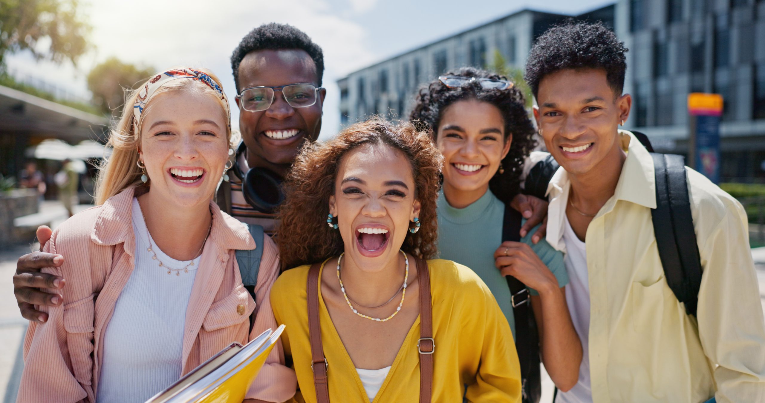 happy-university-portrait-with-friends-class-diversity-college-campus-with-smile-school-education-students-with-support-backpack-outdoor-learning-academy-with-solidarity